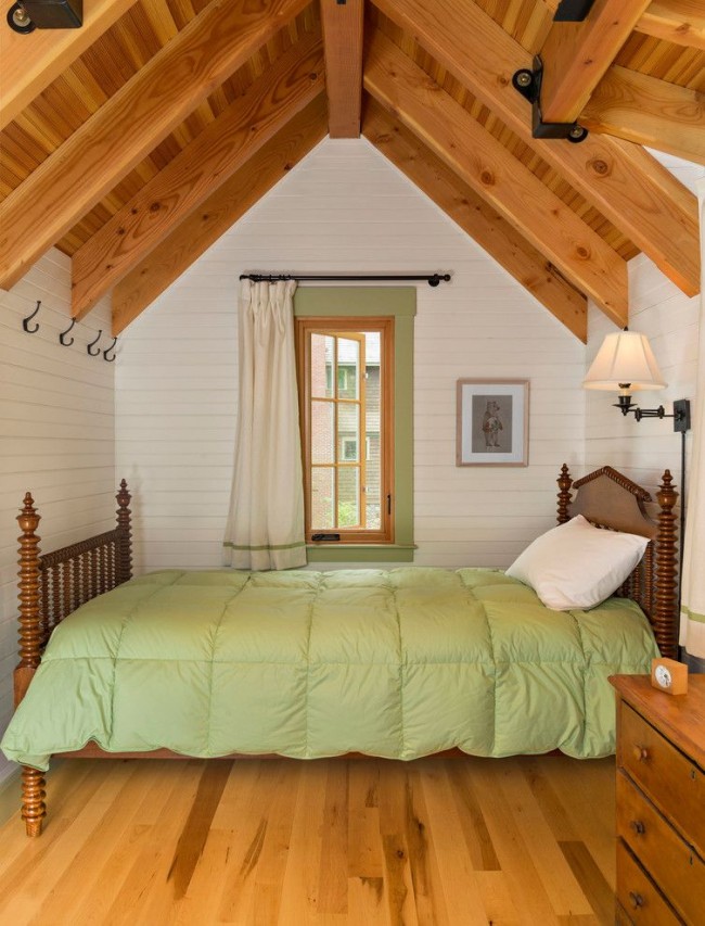 Небольшая и уютная спальня с обилием дерева в интерьере